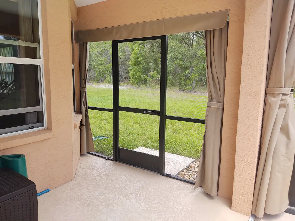 Tan privacy curtains in lanai corner