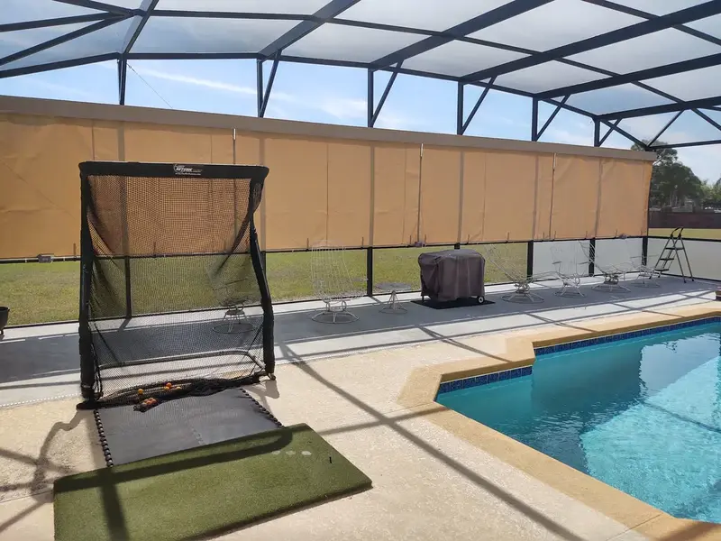 Tan Sunbrella privacy curtains installed in Lakeland FL pool cage