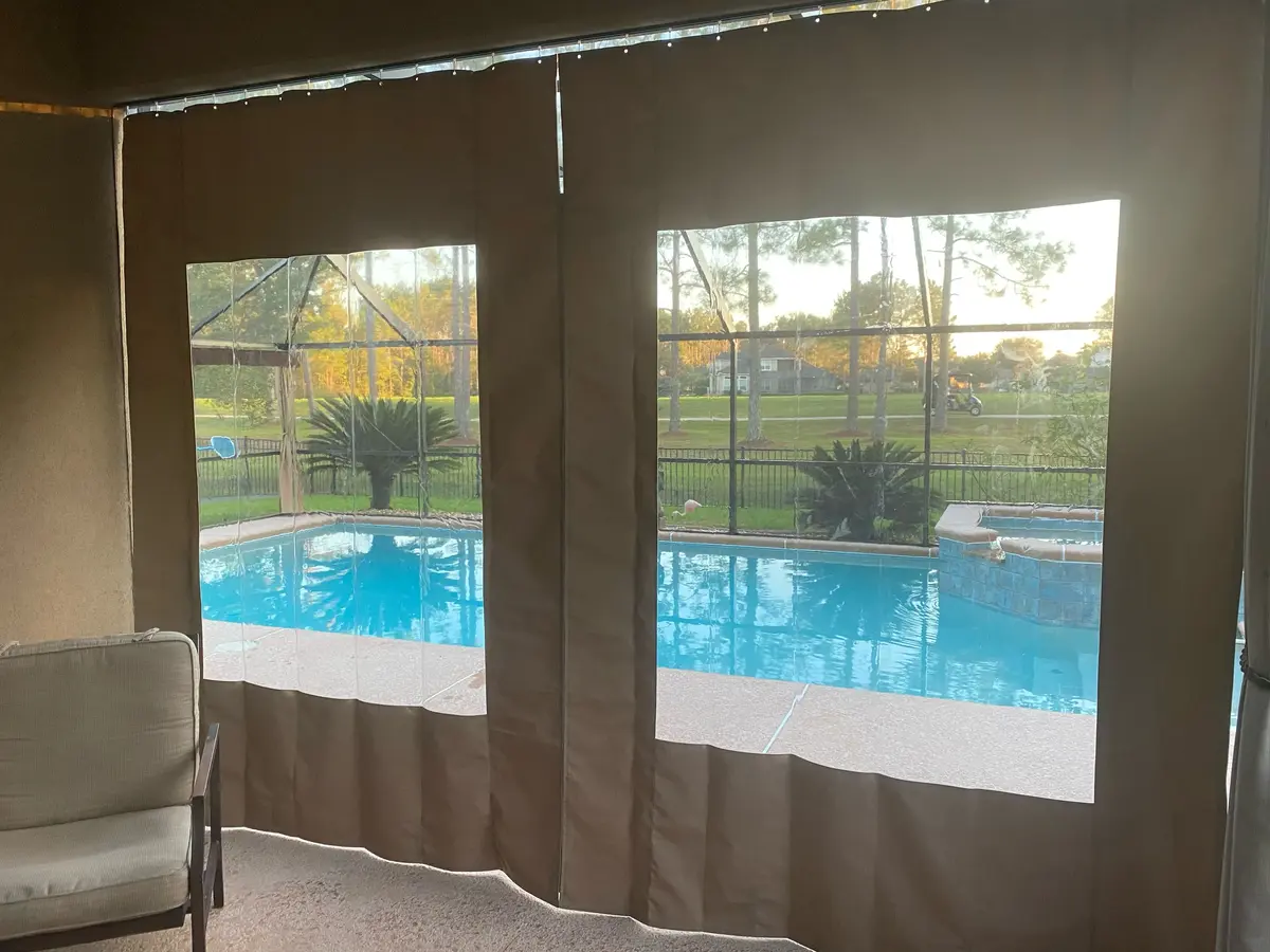 Tan vinyl window curtains with pool view in lanai