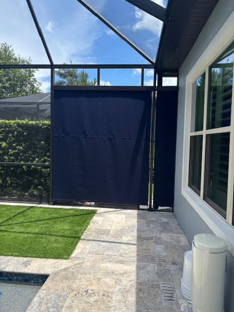 Navy roller shades on lanai alternate view