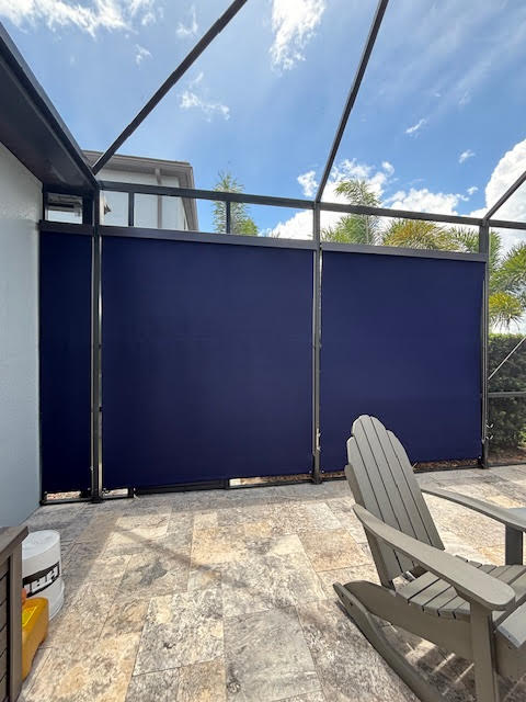 Navy blue roller shades on lanai