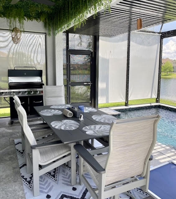 White and grey roller shades with outdoor dining area