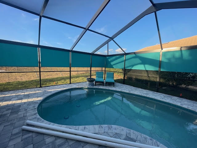 Teal roller shades with backyard and pool view