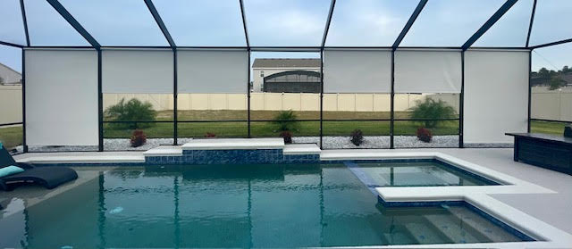 White roller shades on modern pool with spa