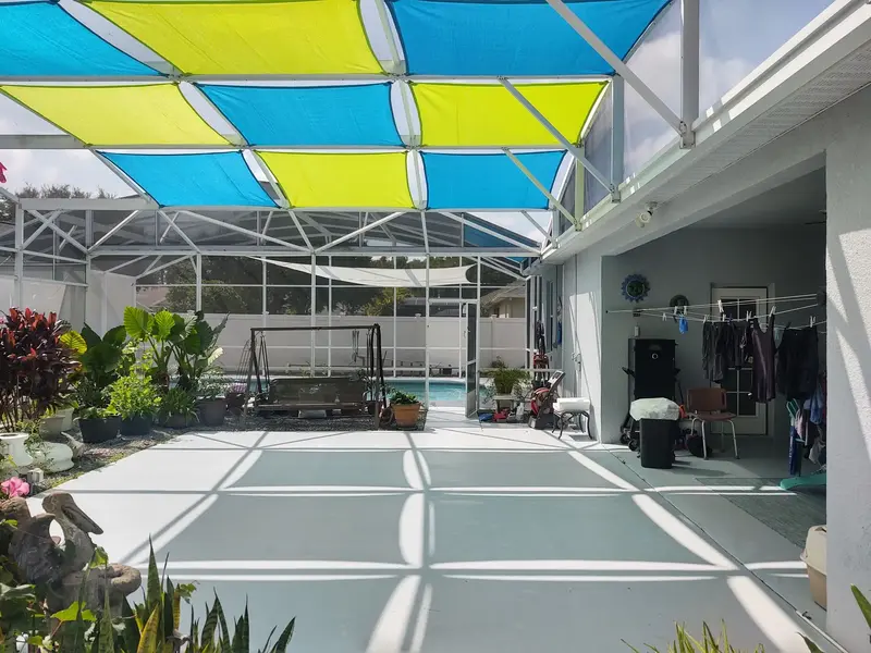 HDPE shade sail panels providing overhead coverage in Orlando pool enclosure