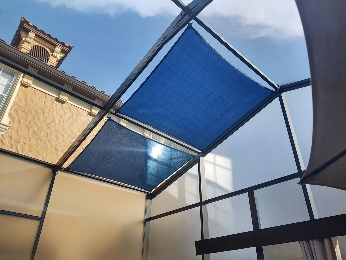 Cream shade sail over pool